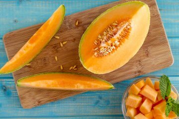 Cantaloupe melon slices on cutting board