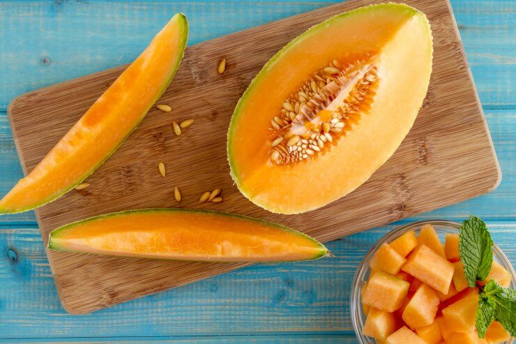 Cantaloupe melon slices on cutting board