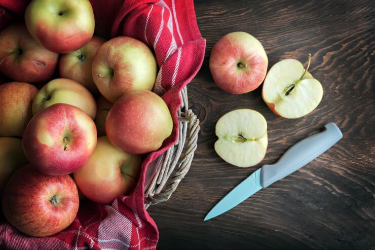 Healthy red apples in basket on a table