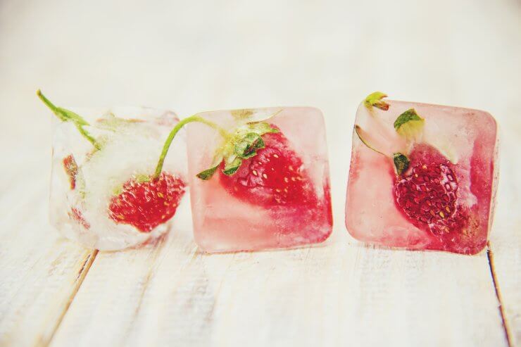 Berries frozen in ice cubes. Selective focus.