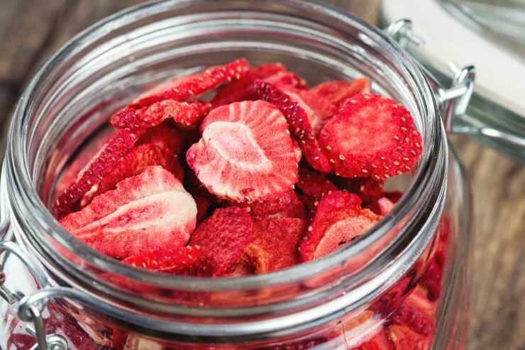 Dehydrated sliced strawberries in a glass jar