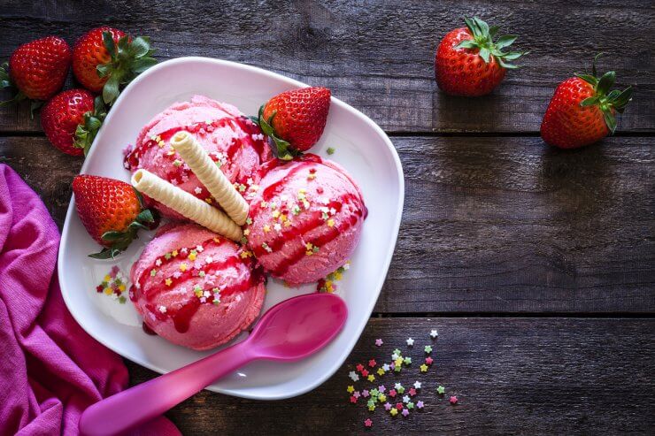 Strawberry ice cream shot on rustic wooden table