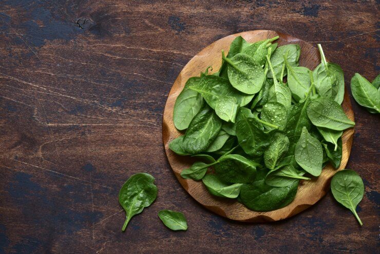 Spinach on wooden board