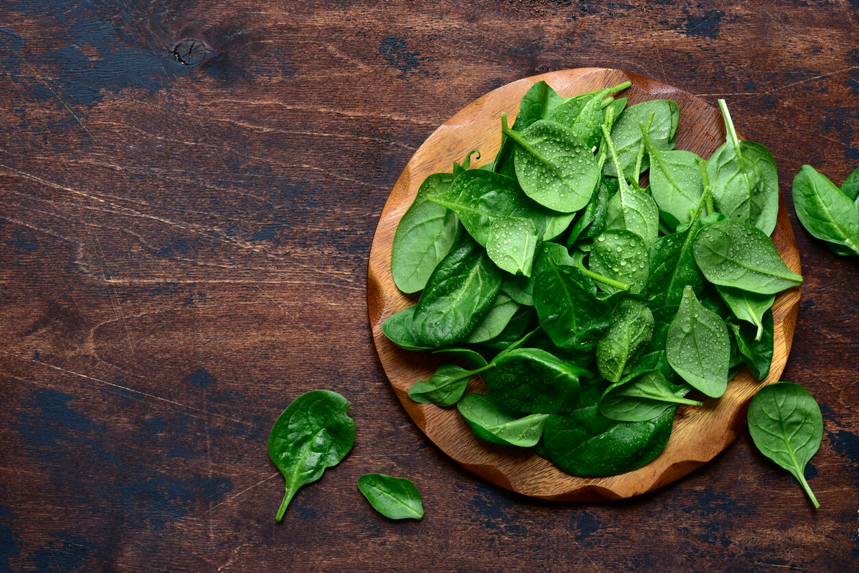 Spinach on wooden board
