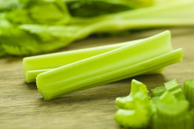 Fresh celery sticks on cutting board