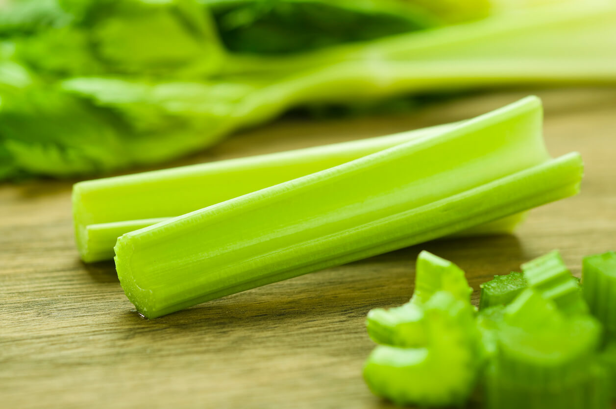 Fresh celery sticks on cutting board