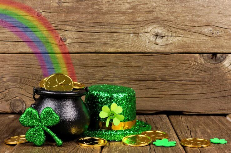 St Patricks Day Pot of Gold with rainbow & decor against wood