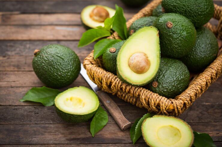 Fresh organic avocado on the wooden table