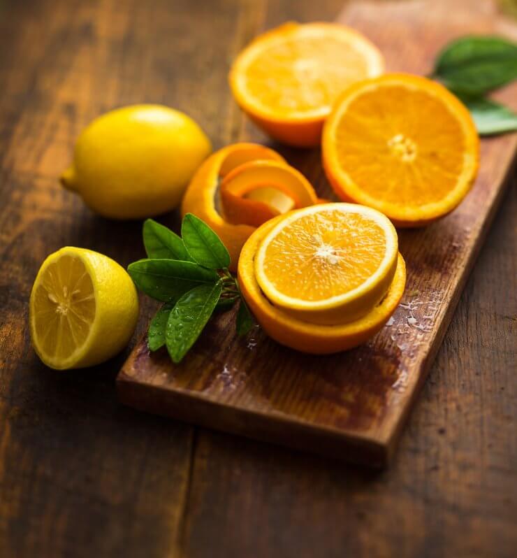 oranges and lemons over a wooden background