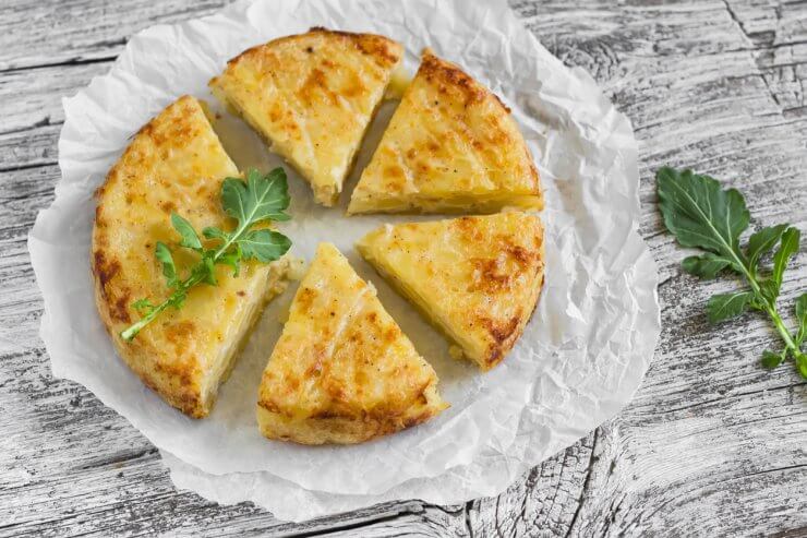 potato tortilla on a light wooden surface